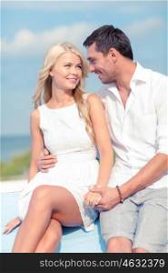 summer holidays and dating concept - smiling couple at sea side. smiling couple at sea side