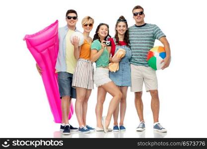 summer holidays and people concept - group of happy smiling friends in sunglasses with beach ball, volleyball, towel, camera and air mattress over white background. happy friends with beach and summer accessories