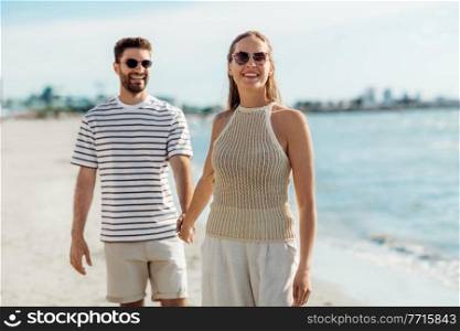 summer holidays and people concept - happy couple on beach in tallinn, estonia. happy couple on summer beach