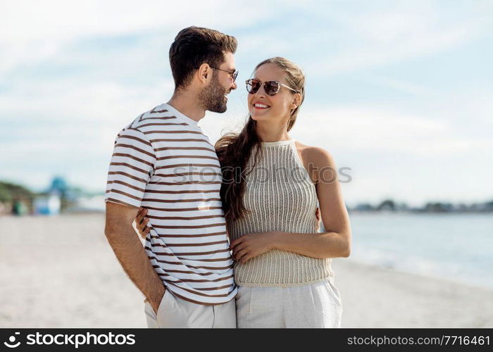 summer holidays and people concept - happy couple on beach in tallinn, estonia. happy couple on summer beach