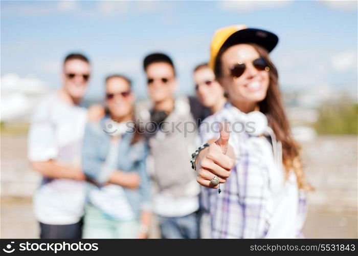 summer holidays and teenage concept - close up of female hand showing thumbs up