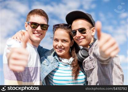 summer holidays and teenage concept - group of smiling teenagers showing thumbs up