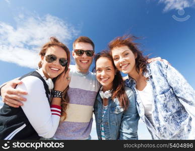 summer holidays and teenage concept - group of teenagers outside