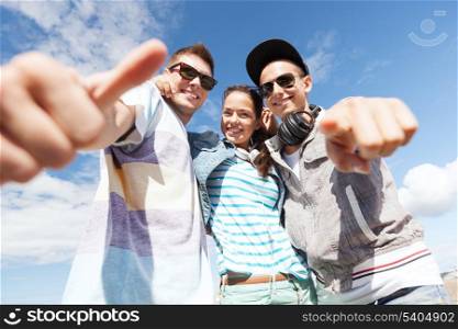 summer holidays and teenage concept - group of teenagers outside