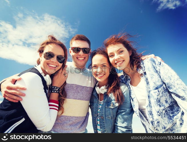 summer holidays and teenage concept - group of teenagers outside