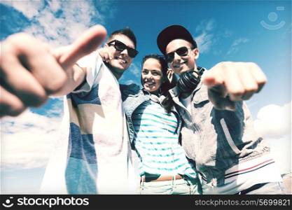 summer holidays and teenage concept - group of teenagers outside