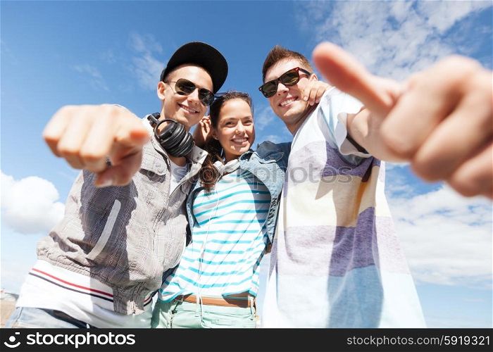 summer holidays and teenage concept - group of teenagers outside. group of teenagers outside