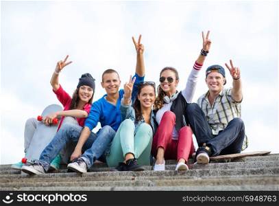 summer holidays and teenage concept - group of teenagers showing finger five gesture. group of teenagers showing finger five