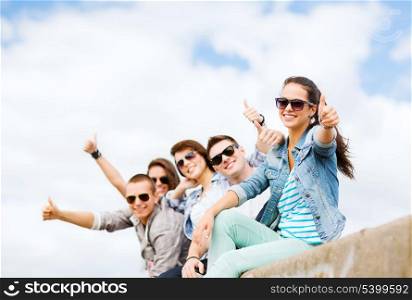 summer holidays and teenage concept - group of teenagers showing thumbs up