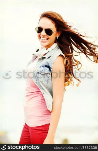 summer holidays and teenage concept - teenage girl in shades outside