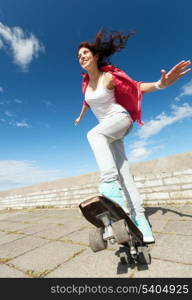 summer holidays and teenage concept - teenage girl skating outside