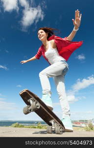 summer holidays and teenage concept - teenage girl skating outside