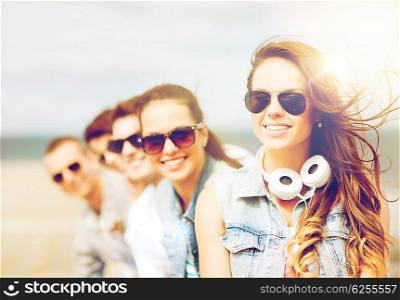 summer holidays and teenage concept - teenage girl with friends outside. teenage girl with friends outside