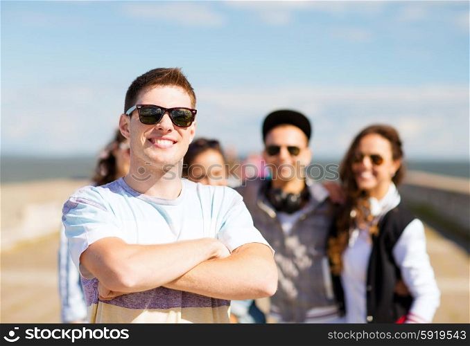 summer holidays and teenage concept - teenager in shades outside with friends. teenager in shades outside with friends