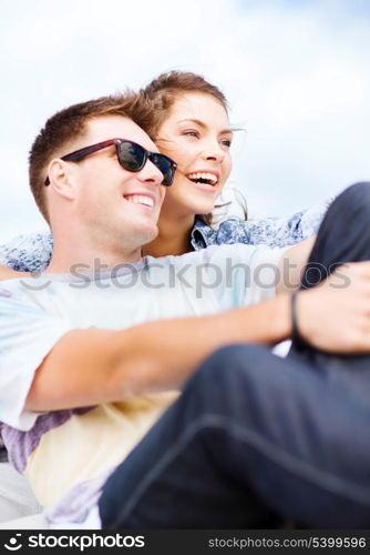 summer holidays and teenage concept - teenagers hanging out outside