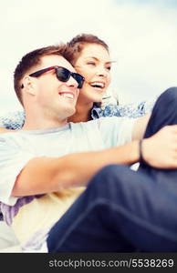 summer holidays and teenage concept - teenagers hanging out outside