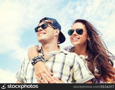 summer holidays and teenage concept - teenagers having fun outside