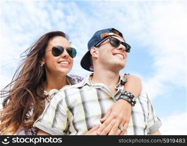 summer holidays and teenage concept - teenagers having fun outside. teenagers having fun outside