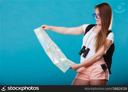 Summer holidays and tourism concept - Attractive young woman long hair sunglasses with backpack read map on blue