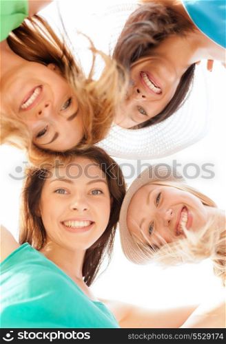 summer holidays and vacation concept - faces of girls looking down and smiling