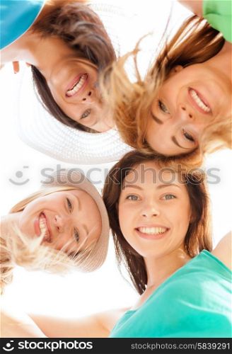 summer holidays and vacation concept - faces of girls looking down and smiling. faces of girls looking down and smiling