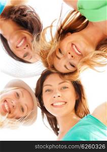 summer holidays and vacation concept - faces of girls looking down and smiling. faces of girls looking down and smiling