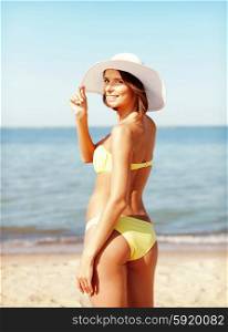 summer holidays and vacation concept - girl in bikini standing on the beach. girl in bikini standing on the beach