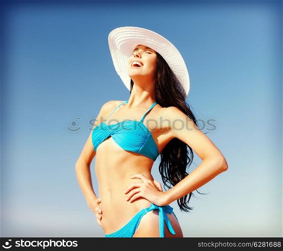 summer holidays and vacation concept - girl in bikini standing on the beach