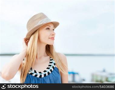 summer holidays and vacation concept - girl in hat standing on the beach