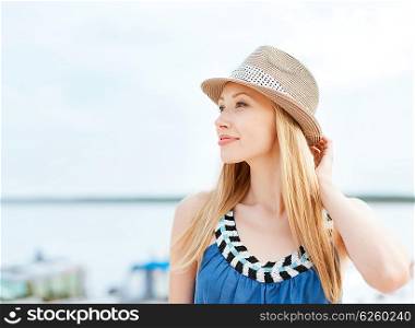 summer holidays and vacation concept - girl in hat standing on the beach. girl in hat standing on the beach