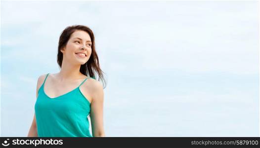 summer holidays and vacation concept - girl standing on the beach
