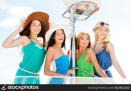 summer holidays and vacation concept - girls on boat or yacht. girls on boat or yacht