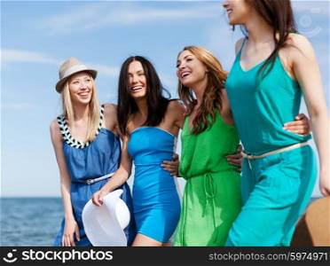 summer holidays and vacation concept - girls walking on the beach. girls walking on the beach