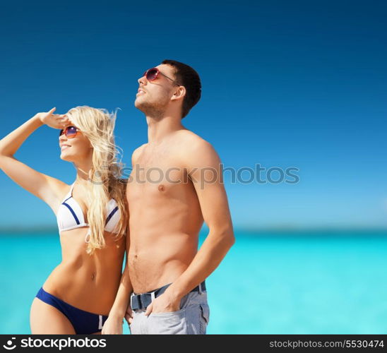 summer holidays and vacation concept - happy couple on the beach