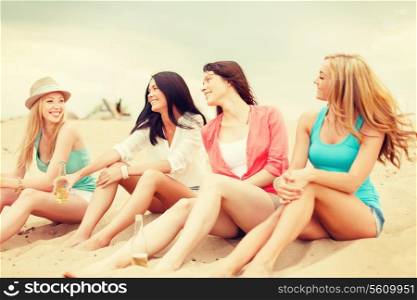 summer holidays and vacation concept - smiling girls with drinks on the beach