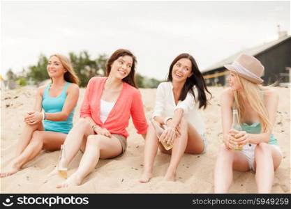 summer holidays and vacation concept - smiling girls with drinks on the beach. smiling girls with drinks on the beach