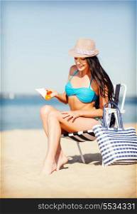 summer holidays and vacation - girl applying sun protection cream