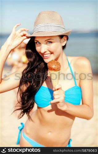 summer holidays and vacation - girl in bikini eating ice cream on the beach. girl in bikini eating ice cream on the beach