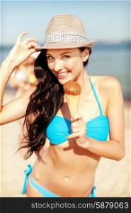 summer holidays and vacation - girl in bikini eating ice cream on the beach. girl in bikini eating ice cream on the beach