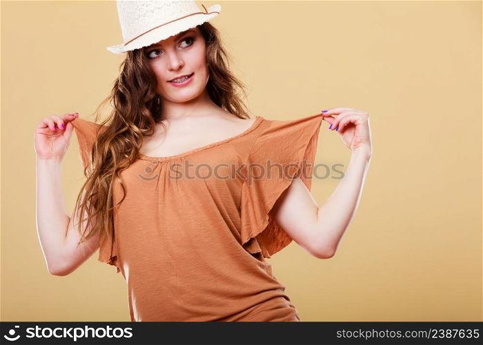 Summer holidays and vacation. Girl in fashionable clothes straw hat. Portrait of attractive woman tourist on bright background