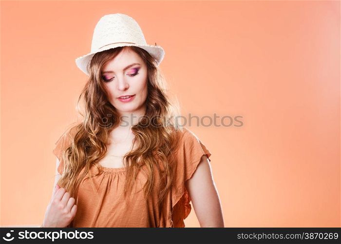 Summer holidays and vacation. Girl in fashionable clothes straw hat. Portrait of attractive woman tourist on brown