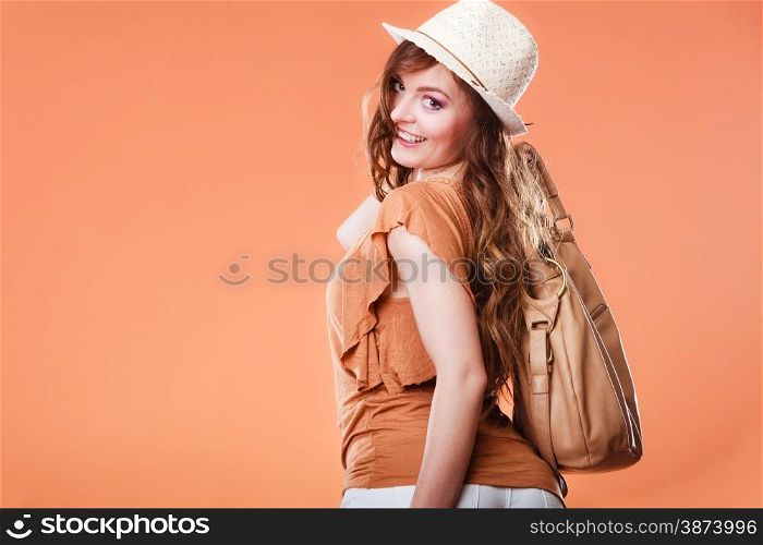Summer holidays and vacation. Girl in fashionable clothes straw hat holding bag handbag. Portrait of attractive woman tourist on brown