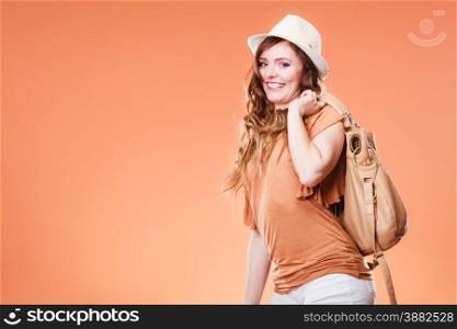 Summer holidays and vacation. Girl in fashionable clothes straw hat holding bag handbag. Portrait of attractive woman tourist on brown