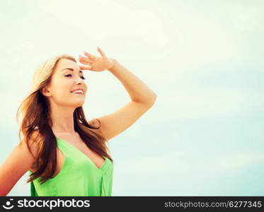 summer holidays and vacation - girl looking for direction on the beach