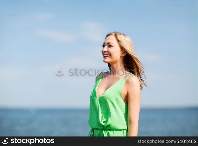 summer holidays and vacation - girl standing on the beach