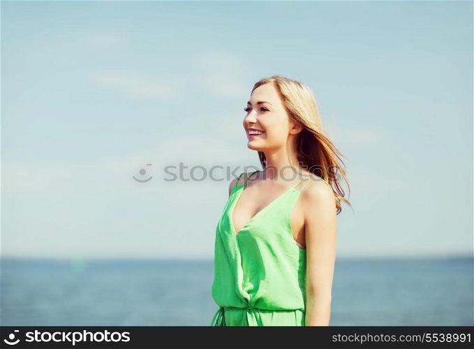 summer holidays and vacation - girl standing on the beach