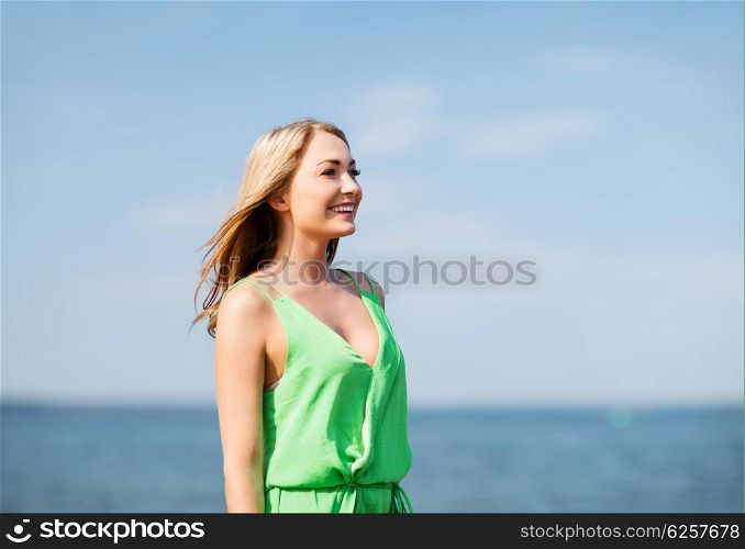 summer holidays and vacation - girl standing on the beach. girl standing on the beach