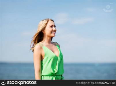 summer holidays and vacation - girl standing on the beach. girl standing on the beach