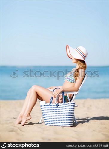 summer holidays and vacation - girl sunbathing on the beach chair