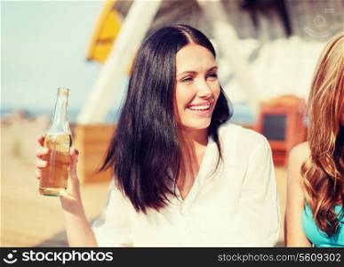 summer holidays and vacation - girl with drink and friends on the beach